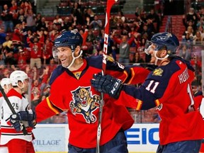 The Florida Panthers’ Jonathan Huberdeau (right) congratulates veteran linemate Jaromir Jagr after a goal. The durable Czech and his Florida teammates have proved the most inspiring/shocking story in the NHL thus far.