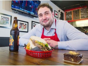 Former BC Lions offensive lineman Jon Hameister-Ries with his Bashaw beef sandwich at his new Davie Street restaurant Meat City Sandwiches.