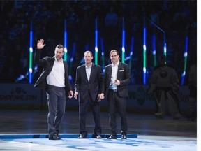 Former Vancouver Canucks linemates Todd Bertuzzi, from left, Brendan Morrison and Markus Naslund, of Sweden, are honoured during a ceremony before the Vancouver Canucks and Buffalo Sabres play an NHL hockey game in Vancouver, B.C., on Monday December 7, 2015.