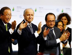 French President Francois Hollande, right, French Foreign Minister and president of the COP21 Laurent Fabius, centre, and United Nations Secretary General Ban ki-Moon applaud after the final conference at the COP21, the United Nations conference on climate change, in Le Bourget, north of Paris, Saturday, Dec.12, 2015. Governments have adopted a global agreement that for the first time asks all countries to reduce or rein in their greenhouse gas emissions.