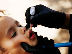 A girl receives a polio vaccination during a house-to-house polio immunization campaign in Sanaa, Yemen, Tuesday, Nov. 10, 2015. A national three-day anti-Polio immunization campaign to vaccinate more than 5 million children across Yemen began on Monday.