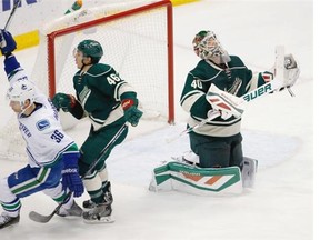 Goaltender Devan Dubnyk of the Minnesota Wild reacts as Vancouver Canucks winger Jannik Hansen celebrates in front of Wild defenceman Jared Spurgeon after scoring the game-winning goal in Wednesday’s NHL game in St. Paul, Minn.