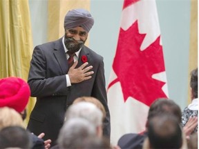 Harjit Sajjan reacts after be­ing sworn in as de­fence minister dur­ing a cere­mony at Ri­deau Hall on Wed­nes­day.