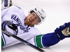 Henrik Sedin #33 of the Vancouver Canucks shows the effect of a boarding major assessed to Mikhail Grabovski #84 of the New York Islanders during the first period at the Barclays Center on January 17, 2016 in the Brooklyn borough of New York City.