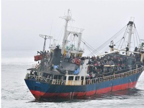 Hundreds of passengers crowd the deck of MV Sun Sea off the coast of B.C. in August 2010.