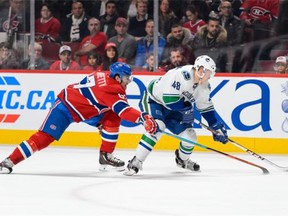 Hunter Shinkaruk, a first-round draft pick in 2013, of the Vancouver Canucks skates with the puck against Max Pacioretty of the Montreal Canadiens at the Bell Centre on Monday. The game marked Shinkaruk’s first NHL game.