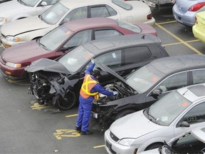 Investigators examine vehicles at the ICBC damaged vehicle lot in Richmond.