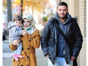 Issa Alwadi and his wife, Alaa Ali, and baby Sham enjoy a walk after recently arriving in Vancouver from Syria.