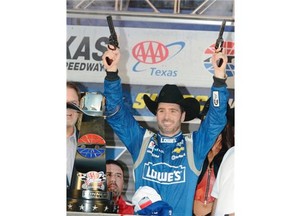 Jimmie Johnson fires pistols in victory lane after winning the NASCAR Sprint Cup Series auto race at the Texas Motor Speedway in Fort Worth, Texas on Sunday. AP Photo/Larry Papke