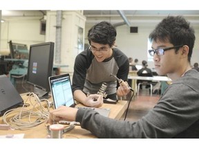 Kenneth Tubungbanua and Mason Liang work on a technology project using the arduino gadget at Templeton secondary school in Vancouver.