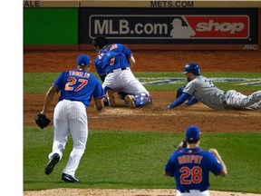 An off-line throw from Lucas Duda (not in photo) to home plate allowed the Kansas City Royals’ Eric Hosmer to score in the ninth inning of Game 5 of the World Series on Sunday at Citi Field in New York. The Royals went on to 7-2 to take the Series four games to one.