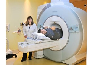 BC Lion Bobby Singh tries out the new MRI in Richmond Hospital in Richmond, January 21, 2010.  MRI teck Terry McCrossan assists Bobby in the machine.