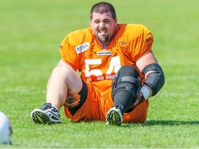 B.C. Lions offensive lineman Dean Valli stretches during practice on Tuesday, Aug. 13, 2013 at the Canadian Football League team’s training facility in Surrey.