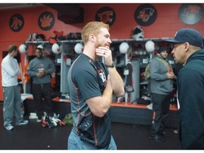 B.C. Lions quarterback Travis Lulay (left) and running back Andrew Harris say their farewells at the club’s training facility in Surrey on Monday, Nov., 16, 2015. The Lions’ season ended Sunday in Calgary with a 35-9 loss to the Stampeders in the CFL West Division semifinal.