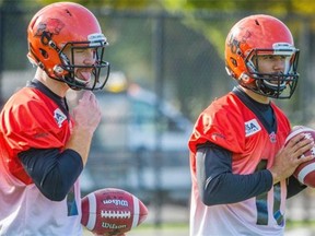 B.C. Lions quarterbacks Travis Lulay (left) and Jonathon Jennings during a team practice last season.