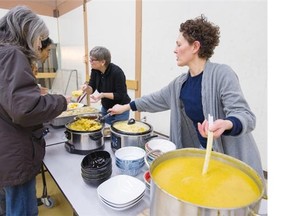 Lupii Cafe owner Lisa Papania (right) serves up a community dinner at the Champlain Heights Community centre in Vancouver on Saturday.