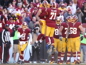 Members of the Washington Redskins celebrate during their regular-season finale against the Dallas Cowboys last Sunday. The redhot Redskins host Green Bay in NFC wild-card action Sunday.