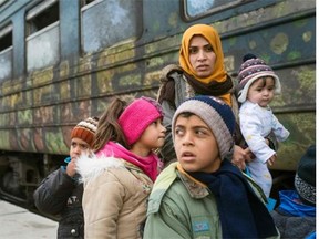 Migrants and refugees board a train heading to Serbia from the Macedonian-Greek border. B.C. will be receiving 1,000 government-sponsored refugees in the next 10 days.