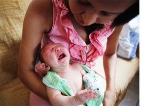 Mother Daniele Santos changes her two-month-old baby Juan Pedro, who was born with microcephaly, on Wednesday in Recife, Pernambuco state, Brazil.