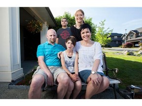 Dawn Thomas-Wightman (middle), and her husband Ray (left) with their three adopted children (from left), Holden, Grace and Maya at their home in Victoria, June 6th, 2015.  Grace and Maya are biological sisters.