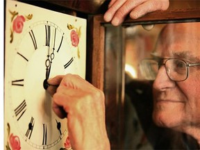 FILE PHOTO — Archie McQuater, 82-year-old clockmaker at Craiglea clocks, adjusts a clock face.