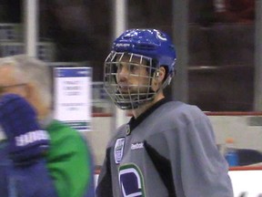 Canucks defenceman who took a slapshot to the face from New York Rangers' Dan Boyle on Dec. 9 returned to the ice to practice wearing a full cage