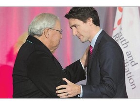 Commissioner Justice Murray Sinclair shakes hands with Prime Minister Justin Trudeau during the release of the final report of the Truth and Reconciliation commission.