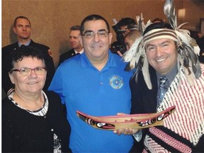L-R: Maureen Thomas, chief of Tsleil-Waututh First Nation, Wayne Sparrow, chief of the Musqueam First Nation, and Ian Campbell, chief of the Squamish First Nation, with the model canoe that was presented to Prime Minister Justin Trudeau.