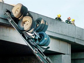 Firefighters were on the scene where a semi truck's trailer tipped over a highway overpass in Langley early Tuesday morning.
