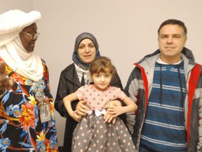 L-R) Abdul Hafiz, 48, his wife Asmaa and daughter Lammar, 4, with Zainab Sourour, an Arabic speaking settlement worker at Surrey School District’s ELL Welcome Centre on King George Boulevard.