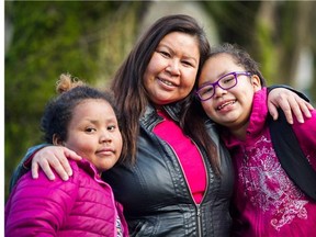 Debbie Henry ( C ) of the Single Mothers Alliance with her daughters Tatiana ( R ), age 9, and Makena ( L ) age 7. Vancouver, February 16 2016.