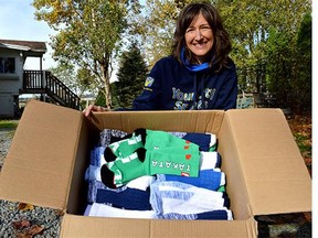 Carolyn Colwell shows off the latest delivery of donated socks to Options Community Services Society's Cloverdale shelter on Colebrook Road.