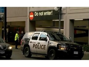 Police and ambulance officials at Johnson Street parkade, where the body of a man was found on Sunday. Dec. 20, 2015.