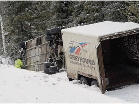 Police investigate a Greyhound bus crash south of Prince George on Thursday, Jan.14, 2016. A Greyhound bus with nine people on board has flipped on its side in icy road conditions on Highway 97.