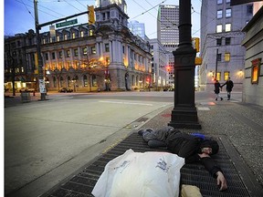 File: A homeless man attempts to stay warm as the cool weather settles in downtown Vancouver. Sixty new temporary winter shelter spaces for homeless men, women and youth are coming to Vancouver.