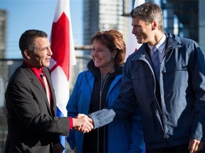 Minister of Fisheries, Oceans and the Canadian Coast Guard, Hunter Tootoo, left, shakes hands with Vancouver Mayor Gregor Robertson, right, as B.C. Premier Christy Clark watches after Tootoo announced the federal government's commitment to reopening the Kitsilano Coast Guard facility, in Vancouver, B.C., on Wednesday December 16, 2015. The facility was closed by the Conservative government in 2013.