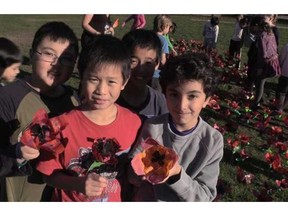 Grade 5 students from Shaughnessy elementary to put poppy display made in class along roadside at city hall today.