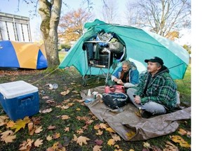Steven L'Heureux, left, and Gord Ross live in a tent city that is growing next to the Victoria courthouse. It began with one or two tents in August but has since expanded to 20 to 30.