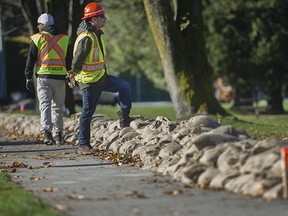 City crews set up sand bags at Locarno beach in Vancouver, BC. November 9, 2015. City of Vancouver and Vancouver Park Board gave an update on the coordinated work, including sandbagging, that is being done to prepare for any possible heavy rains and King Tides that could occur this winter.