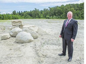 Surrey Coun. Bruce Hayne stands on land in North Surrey back in June where a sports facility has been proposed.