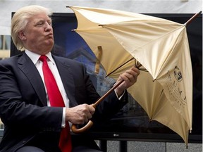 Donald Trump opens a ceremonial umbrella given to him during an announcement in downtown Vancouver, B.C. Wednesday, June 19, 2013. The Trumps were on Canada's west coast to announce the building of Trump International Hotel and Tower Vancouver.