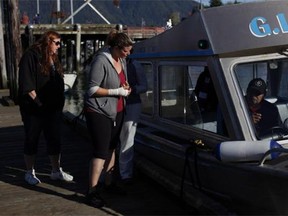 Jenn Newman, a resident of Duncan, B.C., and one of the survivors rescued from the Leviathan II that capsized Sunday, visits First St. dock and the G.I. Charles boat that rescued her, before leaving Tofino, B.C., Monday, October 26, 2015.