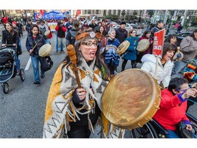 Audrey Siegl, of the Musqueam band, left during a march through the city to bring attention to the global climate change issue Sunday November 29, 2015.