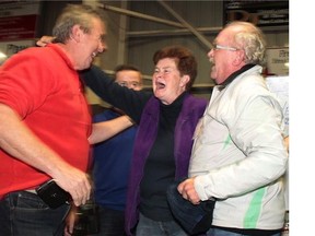 Donelda MacAskill, 62, of Englistown, N.S., receives a cheque for more than $1.7 million after flipping over the ace of spades in the final Chase the Ace draw in Inverness, Nova Scotia on Saturday Oct. 4, 2015. Her biggest purchases so far were both for her husband:a used tractor and a fishing-boat engine.