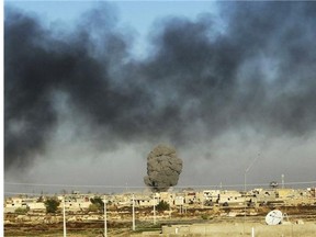 In this Friday, Dec. 25, 2015 photo, smoke rises from Islamic State positions following a U.S.-led coalition airstrike as Iraqi Security forces advance their position in downtown Ramadi, 70 miles (115 kilometers) west of Baghdad, Iraq. Iraqi forces entered the Huz at dawn, an area housing a government compound in the center of Ramadi, part of a major offensive aimed at dislodging the Islamic State terrorist militia from the western city, an Iraqi official said. (AP Photo)