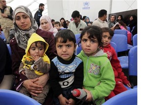 Syrian refugees at a United Nations Refugee Agency registration centre in Lebanon — the country Canada is drawing most of its Syrian refugees from.