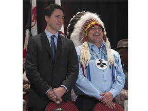 Prime Minister Justin Trudeau and AFN National Chief Perry Bellegarde speak as they arrive at the Assembly of First Nations Special Chiefs Assembly in Gatineau, Tuesday December 8, 2015. THE CANADIAN PRESS/Adrian Wyld