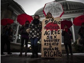 Protestors are seen during rally at Allan Gardens in Toronto on December 20, 2013 to support Toronto sex workers and their rights. THE CANADIAN PRESS/Mark Blinch