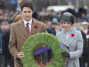 Prime Minister Justin Trudeau and his wife Sophie Gregoire-Trudeau place a wreath at the National War Memorial during Remembrance Day ceremonies in Ottawa, Wednesday, November 11, 2015.