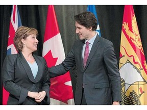 Prime Minister Justin Trudeau speaks with B.C. Premier Christy Clark as he welcomed her Monday to the first ministers meeting on climate change in Ottawa.